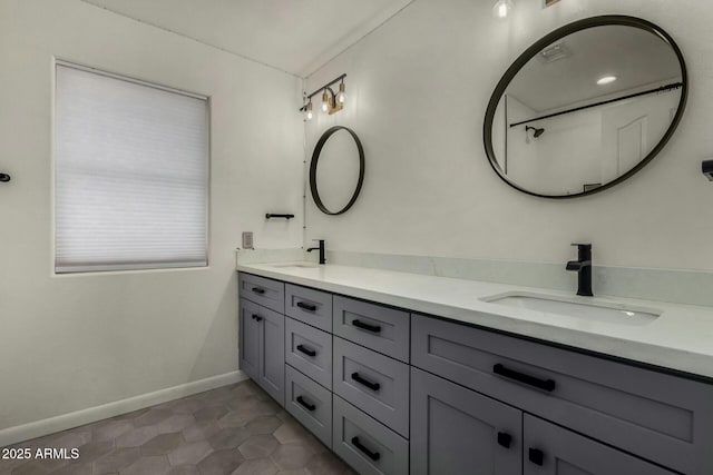 16047 S 14th Dr, Phoenix, AZ 85045 - bathroom with baseboards, double vanity, a sink, and tile patterned flooring
