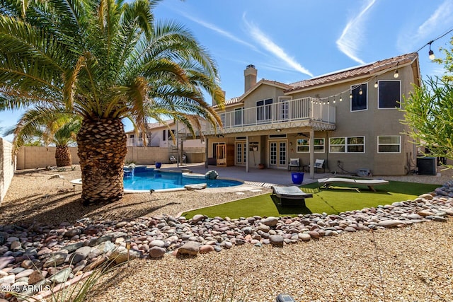 16047 S 14th Dr, Phoenix, AZ 85045 - back of house featuring a fenced backyard, a chimney, stucco siding, and french doors