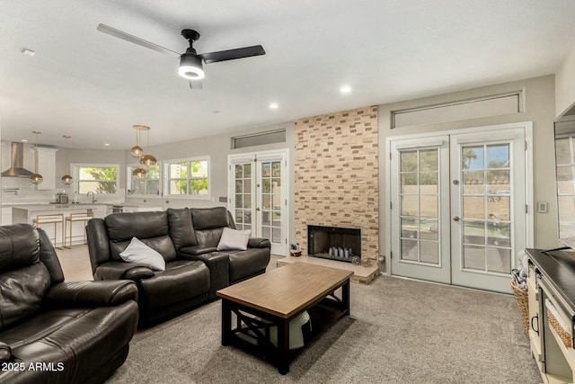 16047 S 14th Dr, Phoenix, AZ 85045 - living area with carpet floors, french doors, a ceiling fan, a large fireplace, and recessed lighting