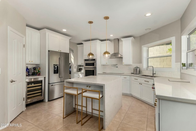 16047 S 14th Dr, Phoenix, AZ 85045 - kitchen featuring wall chimney exhaust hood, tasteful backsplash, appliances with stainless steel finishes, a sink, and beverage cooler