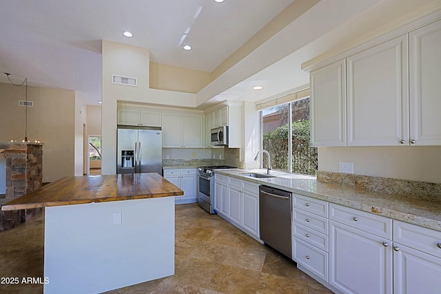 32710 N 71st St, Scottsdale, AZ 85266 - kitchen featuring stainless steel appliances, wooden counters, healthy amount of natural light, a center island, and recessed lighting