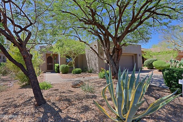 32710 N 71st St, Scottsdale, AZ 85266 - pueblo-style house featuring stucco siding, a garage, and concrete driveway