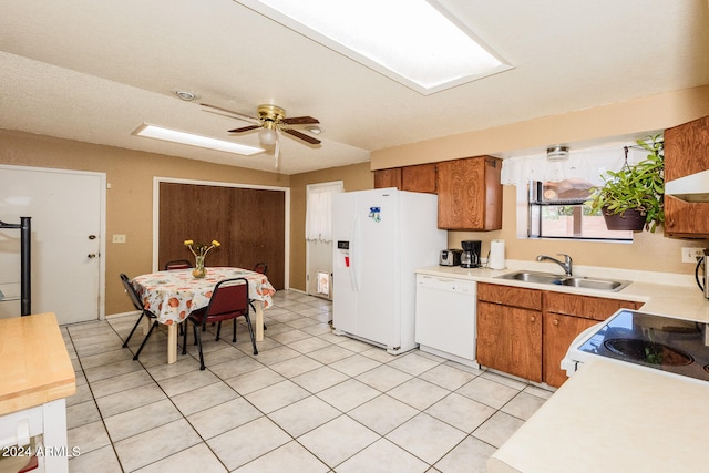 kitchen featuring white appliances, light tile patterned floors, sink, and ceiling fan