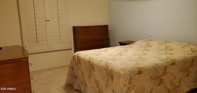 bedroom with light carpet and a closet