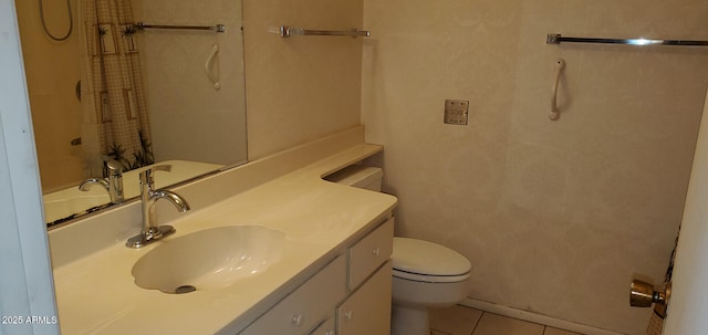 bathroom featuring tile patterned flooring, vanity, and toilet