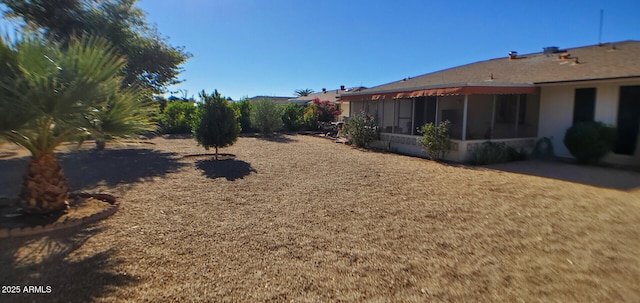 view of yard with a sunroom