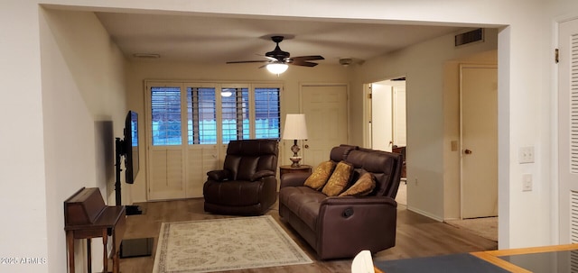 living room featuring hardwood / wood-style floors and ceiling fan