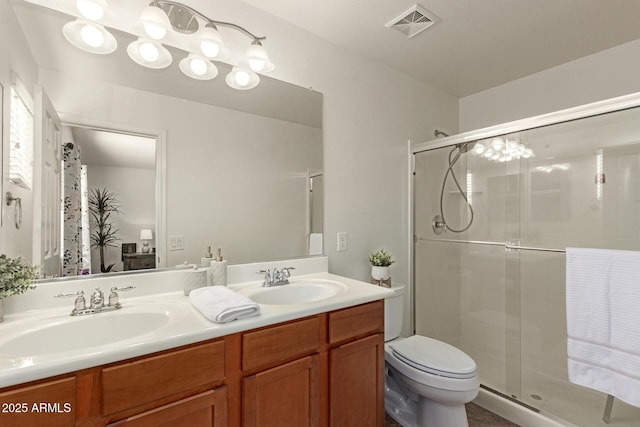 bathroom with toilet, a stall shower, a sink, and visible vents