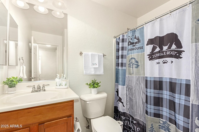 bathroom featuring curtained shower, vanity, and toilet