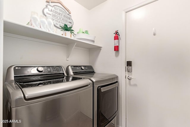 clothes washing area with laundry area and washer and clothes dryer