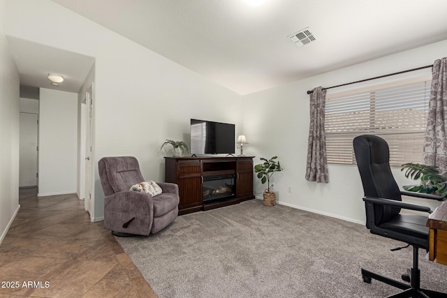 office featuring lofted ceiling, carpet, baseboards, and visible vents