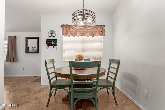 dining space with light tile patterned floors and baseboards