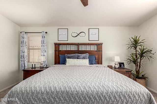 carpeted bedroom with ceiling fan and baseboards