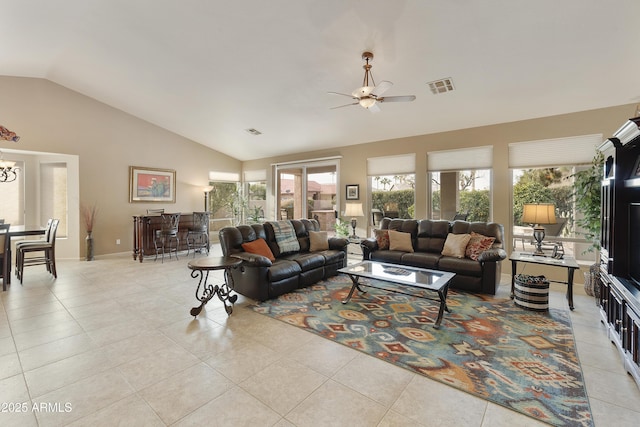 tiled living room with vaulted ceiling and ceiling fan with notable chandelier