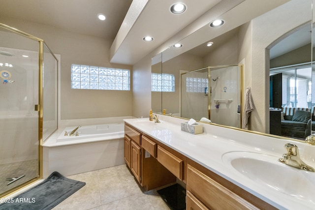 bathroom featuring independent shower and bath, tile patterned flooring, and vanity