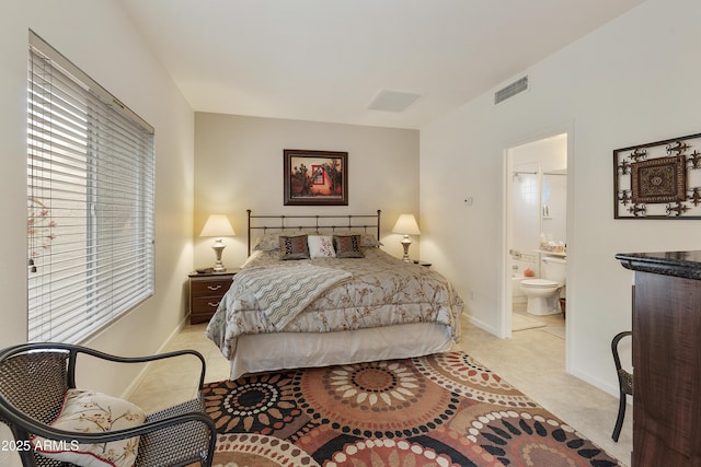 tiled bedroom featuring connected bathroom