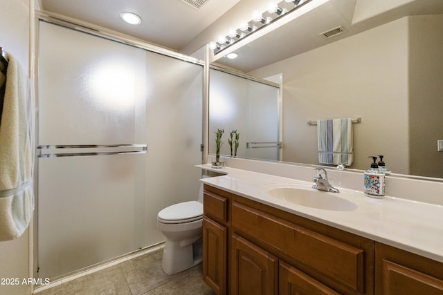 bathroom featuring vanity, a shower with shower door, tile patterned flooring, and toilet