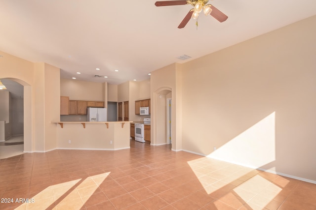 unfurnished living room with ceiling fan and light tile patterned floors