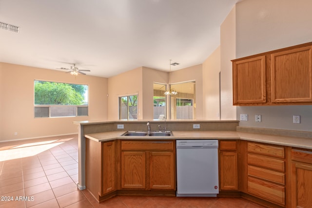 kitchen with hanging light fixtures, dishwasher, light tile patterned flooring, ceiling fan with notable chandelier, and sink