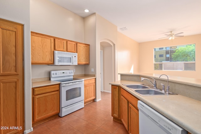 kitchen with sink, light tile patterned flooring, white appliances, and ceiling fan