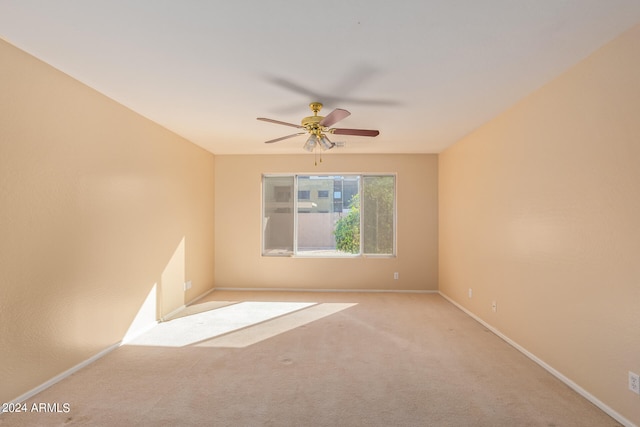 carpeted empty room featuring ceiling fan