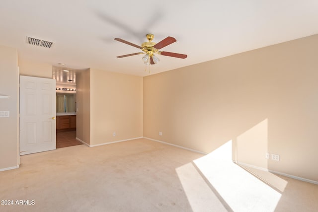 carpeted empty room featuring ceiling fan