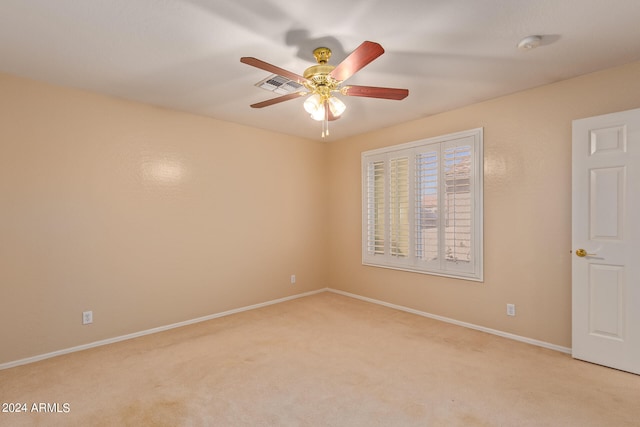 carpeted spare room with ceiling fan