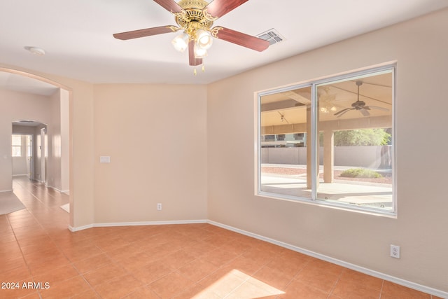 spare room featuring ceiling fan and light tile patterned flooring