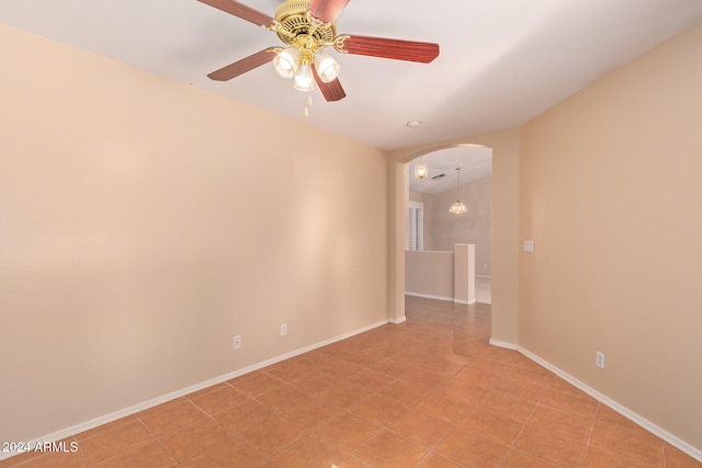 tiled empty room with ceiling fan