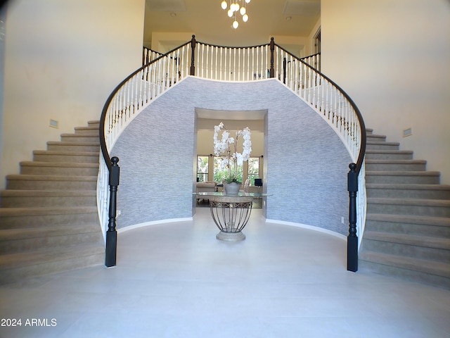 stairs featuring a towering ceiling and concrete flooring