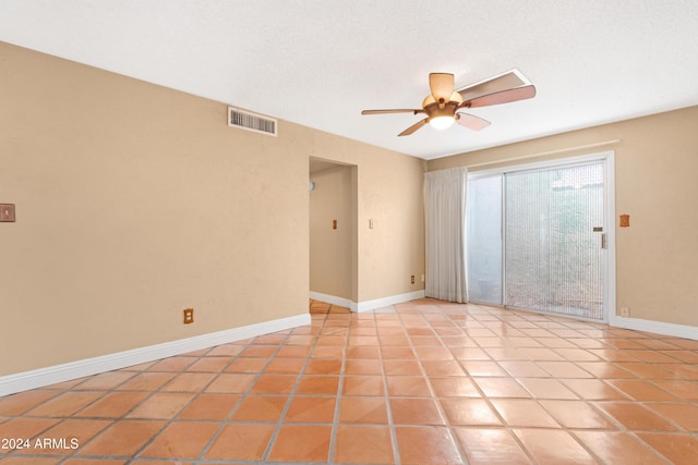 tiled empty room with ceiling fan