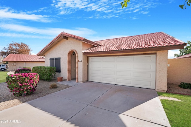 mediterranean / spanish-style home featuring a garage