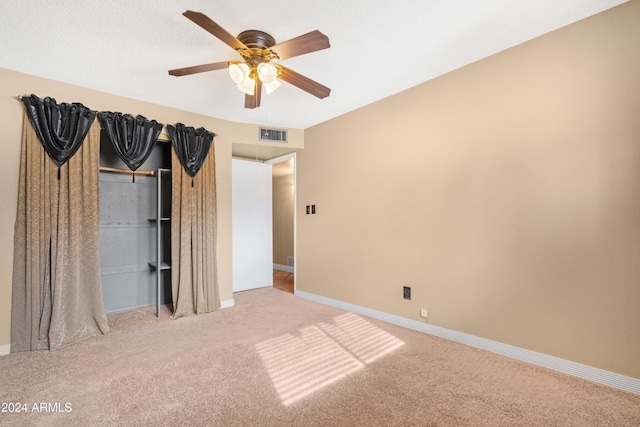 unfurnished bedroom with ceiling fan and carpet