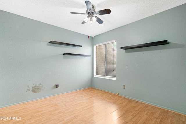 empty room featuring ceiling fan and hardwood / wood-style flooring