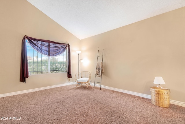 interior space with carpet flooring and vaulted ceiling