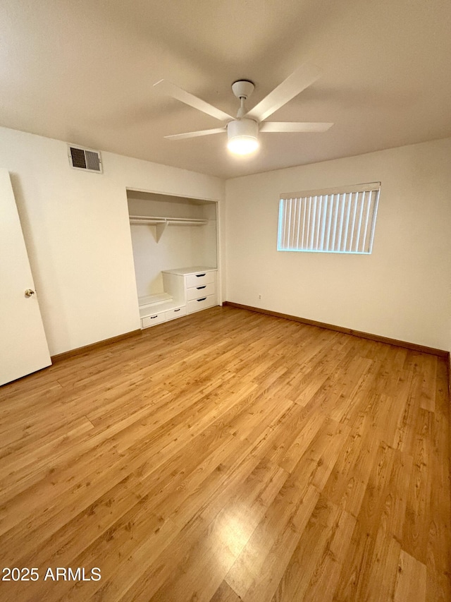 unfurnished bedroom with ceiling fan, light hardwood / wood-style floors, and a closet