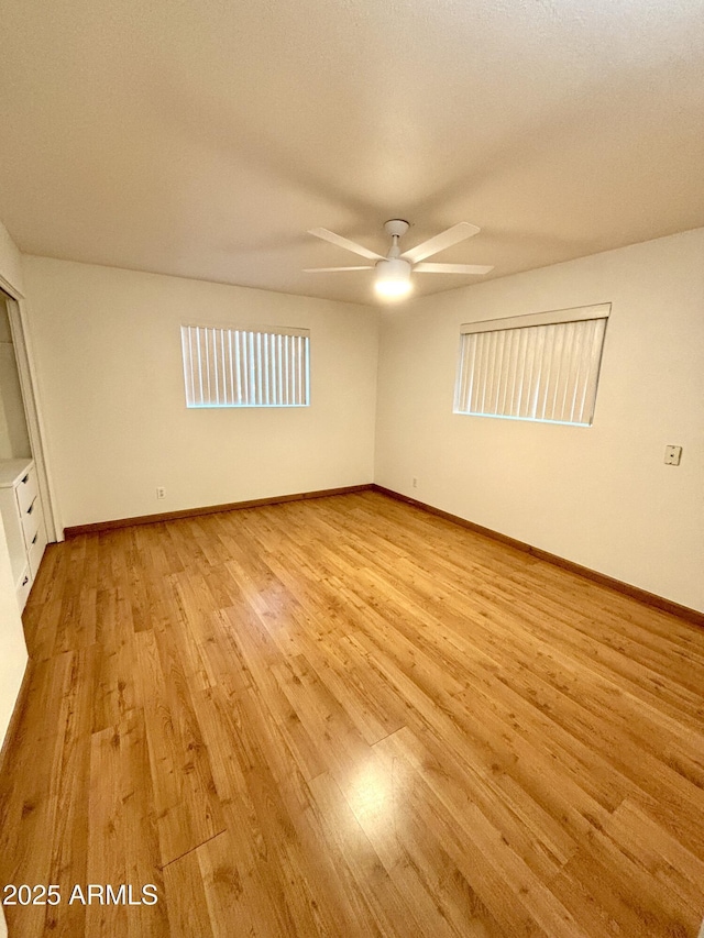 unfurnished room with ceiling fan and light hardwood / wood-style floors