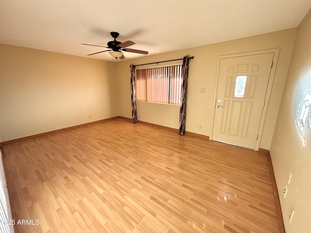 foyer with ceiling fan and light hardwood / wood-style floors