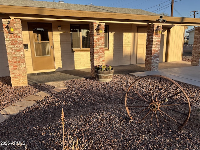 view of exterior entry with a porch