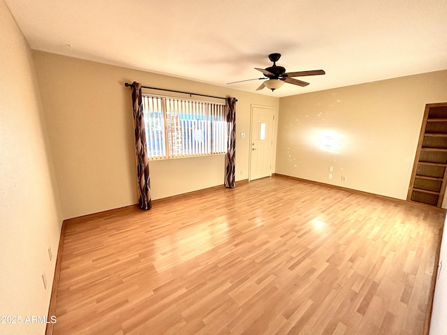 spare room with light hardwood / wood-style floors and ceiling fan