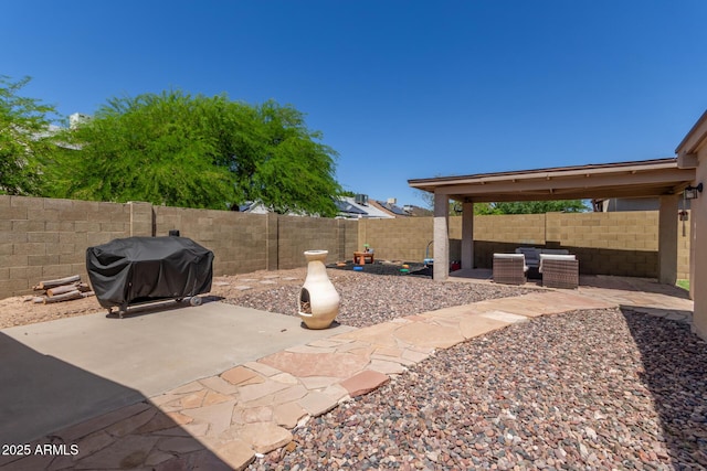 view of patio / terrace featuring a fenced backyard and a grill