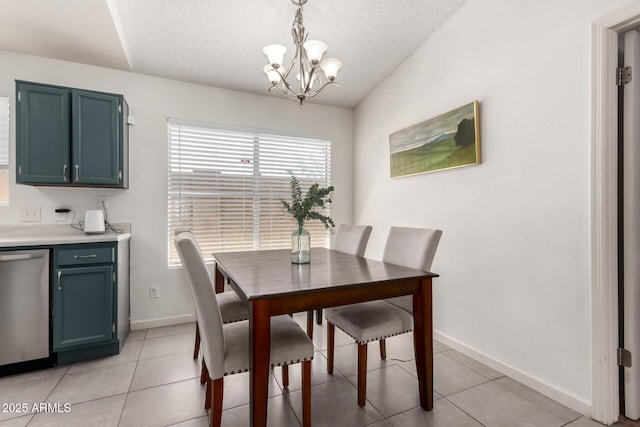 dining space featuring a chandelier, a textured ceiling, and baseboards