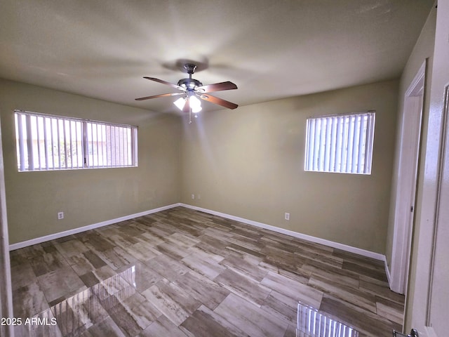 spare room featuring baseboards and ceiling fan