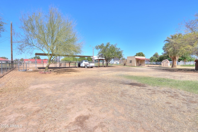 18622 E Via De Arboles, Queen Creek, AZ 85142 - view of yard with an outbuilding, a detached carport, a shed, and fence