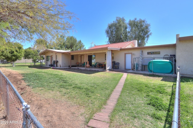 18622 E Via De Arboles, Queen Creek, AZ 85142 - rear view of house featuring fence, a yard, stucco siding, a tiled roof, and a patio area