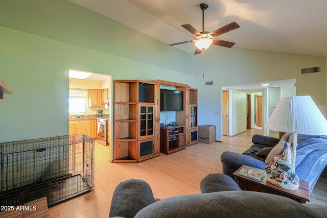 18622 E Via De Arboles, Queen Creek, AZ 85142 - living room with light wood finished floors, visible vents, high vaulted ceiling, and ceiling fan