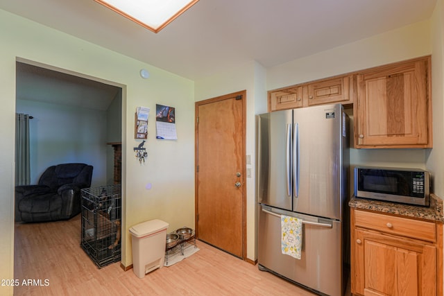18622 E Via De Arboles, Queen Creek, AZ 85142 - kitchen with dark stone countertops, light wood-style floors, and appliances with stainless steel finishes