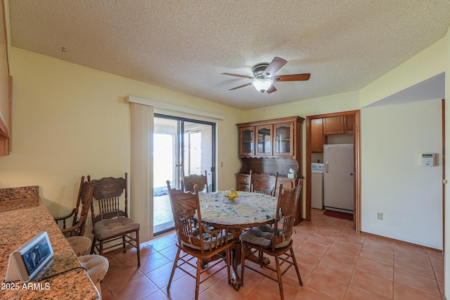 18622 E Via De Arboles, Queen Creek, AZ 85142 - dining room featuring washer / dryer, light tile patterned floors, a ceiling fan, and a textured ceiling