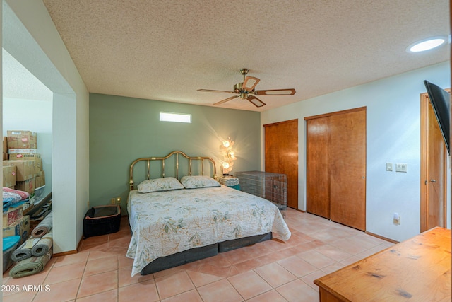 18622 E Via De Arboles, Queen Creek, AZ 85142 - bedroom featuring light tile patterned floors, baseboards, two closets, and a textured ceiling