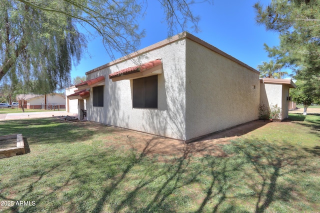 18622 E Via De Arboles, Queen Creek, AZ 85142 - view of side of property with a garage, stucco siding, and a yard